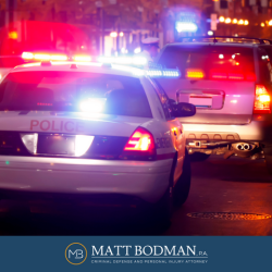 Police car with flashing lights stops a vehicle as the driver is suspected of driving under the influence